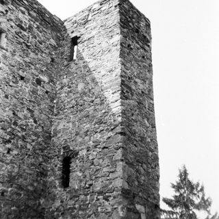 Stone medieval tower with small windows.