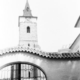 Historic church tower with arched bell window.