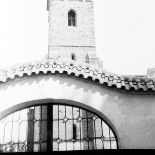 Historic church tower with arched bell window.