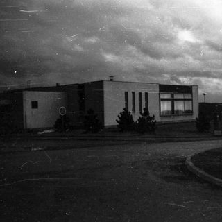 Abandoned building with cloudy sky.