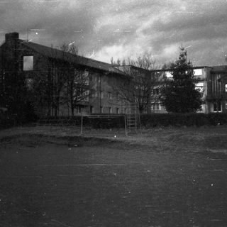 Large building complex in empty courtyard.
