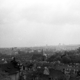 Urban landscape with historic buildings, foggy skyline.