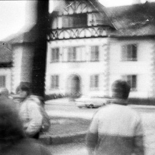 Blurred street scene with traditional half-timbered building.