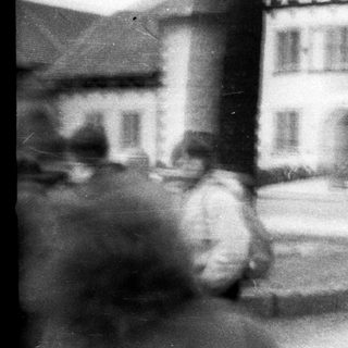 Blurred street scene with traditional half-timbered building.