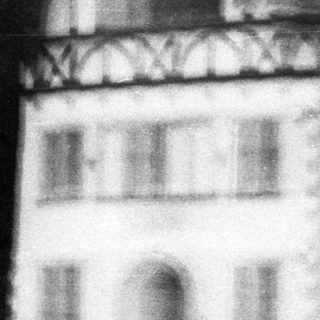 Blurred street scene with traditional half-timbered building.