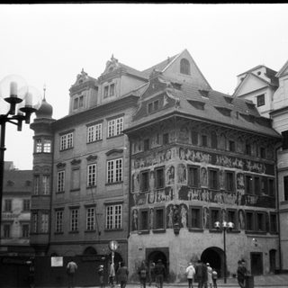 Historic European town square with ornate Renaissance-style building.