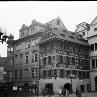Historic European town square with ornate Renaissance-style building.