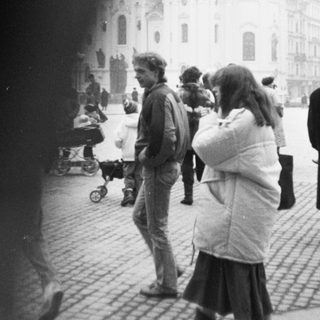 Baroque church with people in public square.