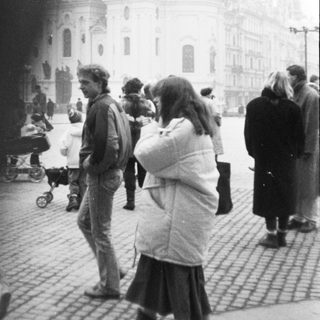 Baroque church with people in public square.