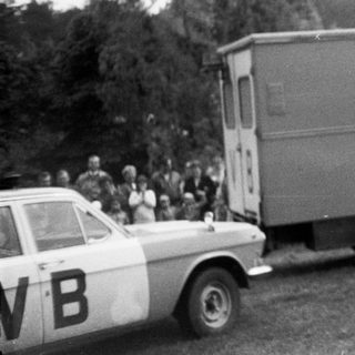 Person jumping over moving truck labeled VB.