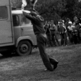 Person jumping over moving truck labeled VB.
