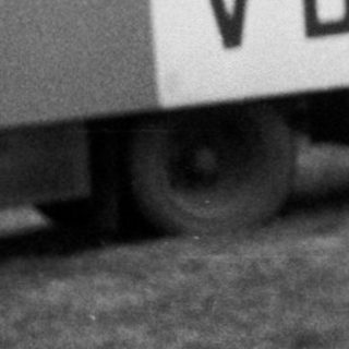 Person jumping over moving truck labeled VB.