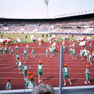 Pre-match warm-up drill with team players on stadium track.