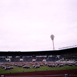 Massive stadium event with coordinated marching formations.