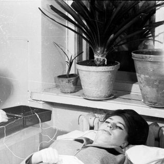 Medical procedure involving EEG brainwave monitoring.