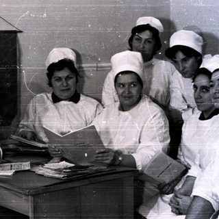 Nurses and doctor in 1950s-60s medical facility uniforms.