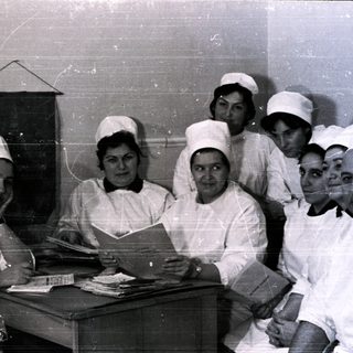 Nurses and doctor in 1950s-60s medical facility uniforms.