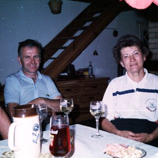 Family gathering enjoying drinks and food indoors.