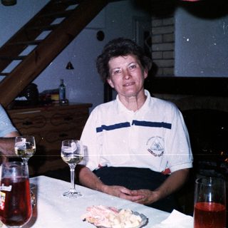 Family gathering enjoying drinks and food indoors.