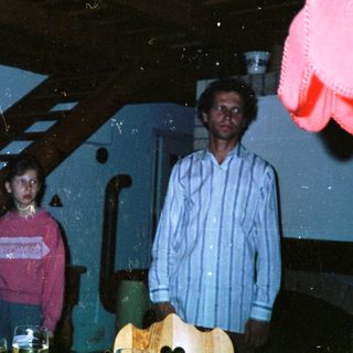 Group of people indoors, possibly at a gathering.