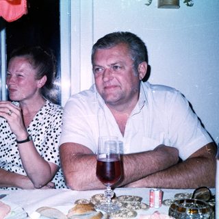 Couple enjoying drinks at a dinner table.