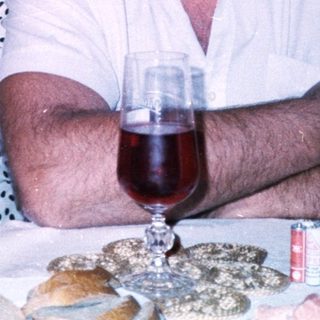 Couple enjoying drinks at a dinner table.