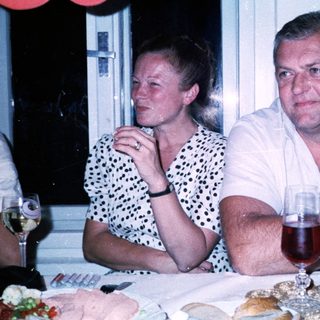 Couple enjoying drinks at a dinner table.