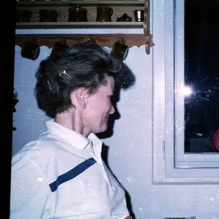 Two women seated indoors, engaged in conversation.