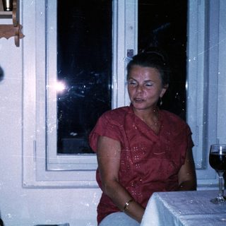 Two women seated indoors, engaged in conversation.