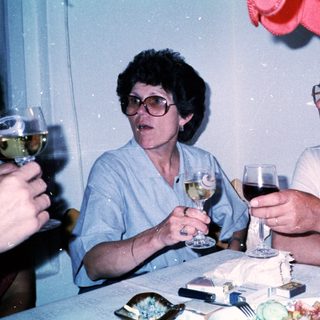 Two people enjoying drinks at a celebratory table.