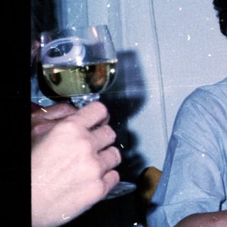 Two people enjoying drinks at a celebratory table.