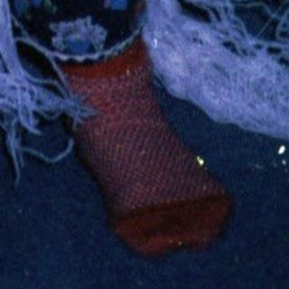 Person in elaborate crochet flamenco dress dancing indoors.