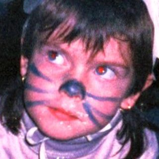 Child in costume crawling on floor.
