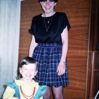 Two women celebrating a birthday with cake.