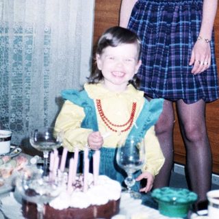 Two women celebrating a birthday with cake.