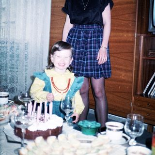 Two women celebrating a birthday with cake.