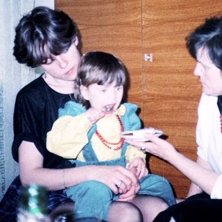 Family moment with grandmother and child playing together indoors.