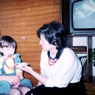 Family moment with grandmother and child playing together indoors.