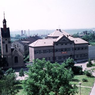 Historic church and institutional building in park-like setting.