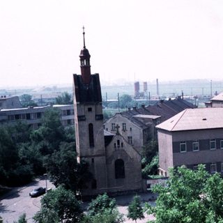 Historic church and institutional building in park-like setting.