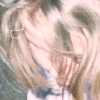 Dog blowing out birthday candles on cake.