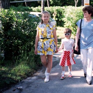 Family walking together outdoors in a park.