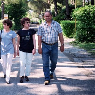 Family walking together outdoors in a park.