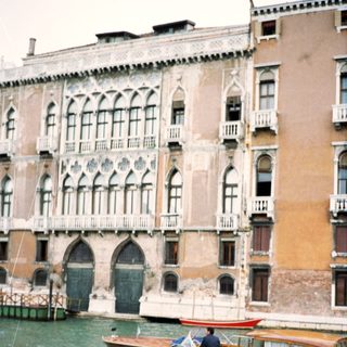 Classic Venetian gondola gliding past historic canal buildings.