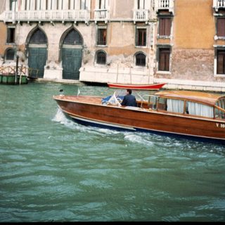 Classic Venetian gondola gliding past historic canal buildings.