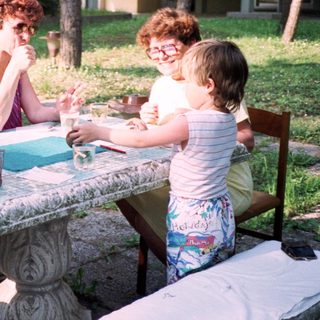 Family enjoying outdoor picnic with crafts.