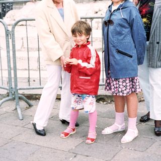 Family group posing in front of historic Piazza San Marco.