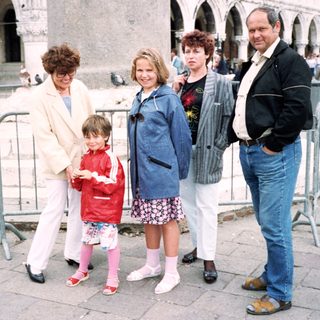 Family group posing in front of historic Piazza San Marco.