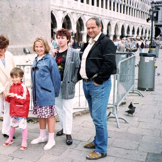 Family group posing in front of historic Piazza San Marco.
