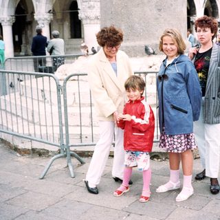 Family group posing in front of historic Piazza San Marco.